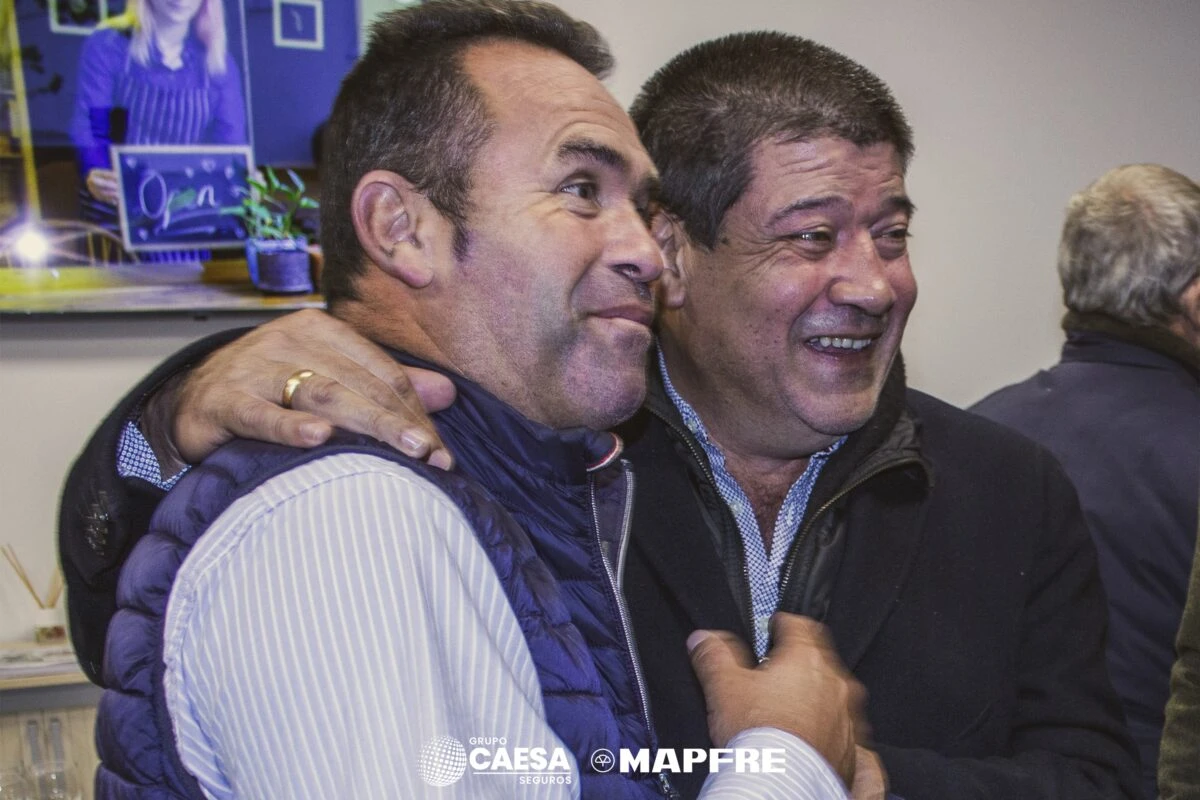 Reencuentro entre dos invitados durante el acto de inauguración